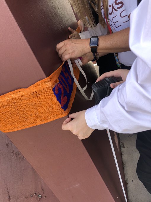 students wrapping post with burlap